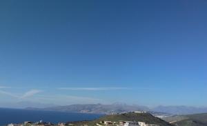 a view of the ocean from a hill at Mihal Suites in Sarandë