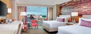 a hotel room with two beds and a window at Mandalay Bay in Las Vegas