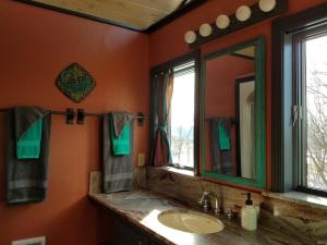 a bathroom with a sink and a mirror at Starry Nights Ranch Bed & Breakfast in Mancos