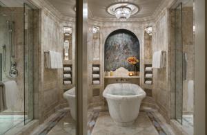 
a bathroom with a bath tub, toilet and sink at Four Seasons Hotel Lion Palace St. Petersburg in Saint Petersburg
