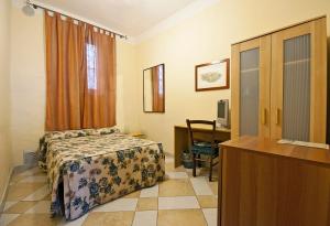 a hotel room with a bed and a desk at Al Mercato B&B in Siena