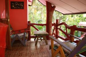 a porch of a house with chairs and a table at Varinda Resort in Lamai