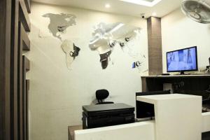 an office with a wall with a map of the world at Hotel Delma in Chennai