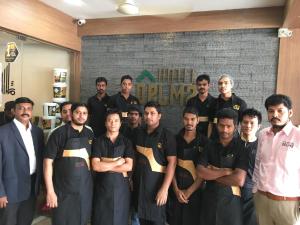 a group of men posing for a picture in a kitchen at Hotel Delma in Chennai