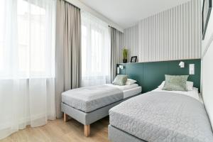 Posteľ alebo postele v izbe v ubytovaní Old Town LTC - Apartments Starówka Tobiasza