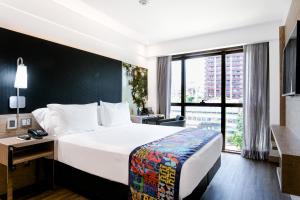Llit o llits en una habitació de Arena Ipanema Hotel