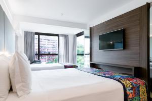 Llit o llits en una habitació de Arena Ipanema Hotel