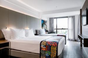 Llit o llits en una habitació de Arena Ipanema Hotel