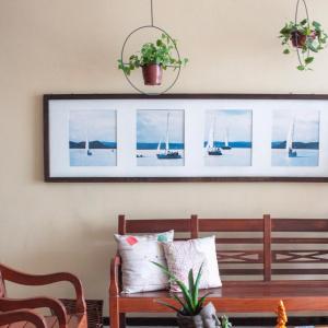 a bench in a room with a picture of boats at Pousada Mucuripe in Fortaleza