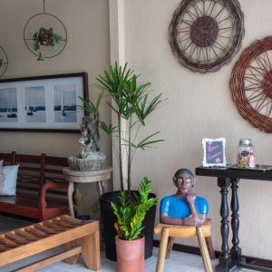 a living room with a doll sitting on a chair at Pousada Mucuripe in Fortaleza