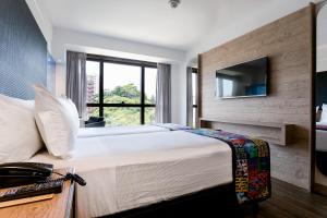 Llit o llits en una habitació de Arena Ipanema Hotel