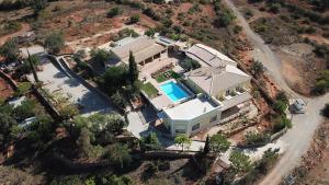 an overhead view of a house with a swimming pool at Quinta do Mocho Turismo Rural in Estói