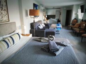 a bedroom with a bed with a pair of slippers at Hostal Casa Nautilus in Cádiz