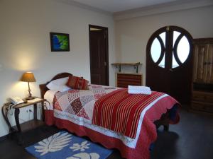 Schlafzimmer mit einem Bett und einem Tisch mit einem Telefon in der Unterkunft Hostal Bivouac in La Paz