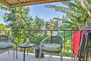 a balcony with two chairs and a table at Downtown Long Beach Condo - 1 Mi to Boardwalk! in Long Beach