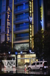 a white suv parked in front of a building at Lazz By Ketenci Hotel in İzmir