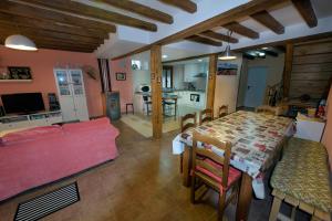 a living room with a table and a couch at El Chorrón in El Royo