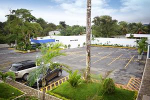 a parking lot with a car parked in it at Hotel Gran Costa Azul in Puerto Santo Tomás de Castilla