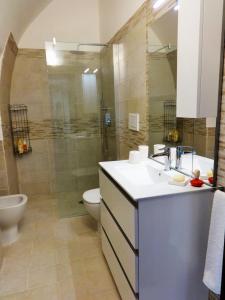 a bathroom with a sink and a toilet and a shower at Monteferraro Vacanze in Turi