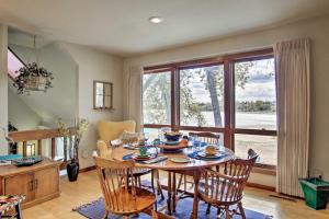 a dining room with a table and chairs and a large window at Lakefront Fort Collins Townhome, Only 3 Mi to CSU! in Fort Collins