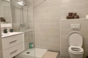 a white bathroom with a shower and a toilet at Great studio with a sea view and parking in 400 meters from Monaco in Beausoleil