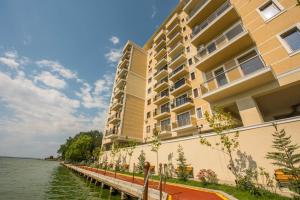 a large building next to a body of water at Solid Residence Apartamente in Mamaia
