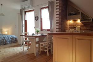 a kitchen and living room with a table and a bed at Castle View Nest in Bled
