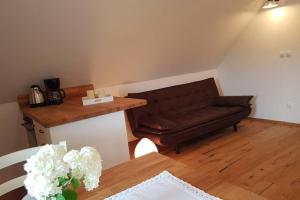 a living room with a couch and a table at Castle View Nest in Bled