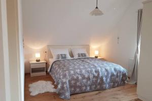 a bedroom with a large bed with two tables and two lamps at Castle View Nest in Bled