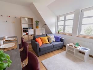 a living room with a couch and a table at Gästeapartment auf einem Bauernhof in Bad Bentheim