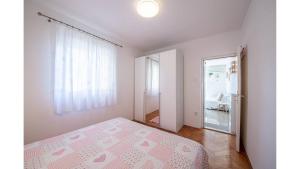 Postel nebo postele na pokoji v ubytování Apartments Magdalena