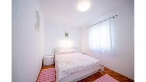 Postel nebo postele na pokoji v ubytování Apartments Magdalena