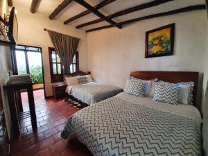 Giường trong phòng chung tại Hotel Quinta de Santa Ana