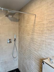 a bathroom with a shower with a shower head at Akropolis Hotel in Nuremberg