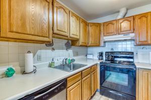 eine Küche mit Holzschränken und einer Spüle in der Unterkunft Bayview Cottage in Barview