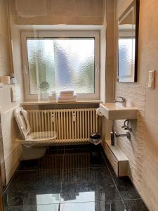 a bathroom with a sink and a window at Akropolis Hotel in Nuremberg