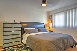 a bedroom with a large bed and a dresser at Downtown Long Beach Condo - 1 Mi to Boardwalk! in Long Beach