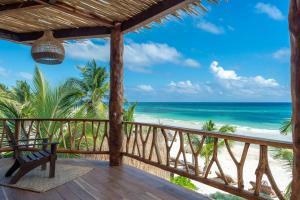 a room with a view of the beach at Casa Ganesh Tulum in Tulum