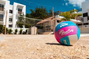 a soccer ball on the ground in front of a house at Villas Palmar Holbox in Holbox Island