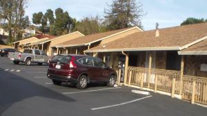 a car parked in a parking lot next to a building at Laurel Inn in Oakland