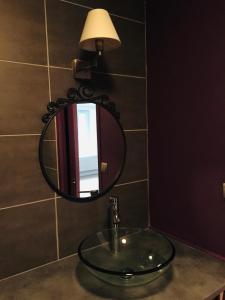 a bathroom sink with a mirror on a wall at Gîte de vac’s et d’affaires à Monthermé in Monthermé