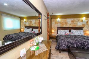 a hotel room with two beds and a mirror at Hotel Mansion del Cantador in Guanajuato +48 photos