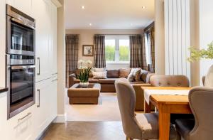 a living room with a couch and a table at The Penthouse @ Carus Green in Kendal