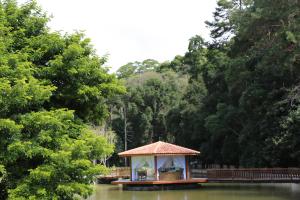 a gazebo in the middle of a river with trees at Spazio di Garda in São Roque
