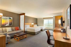 a hotel room with a bed and a couch at Hyatt Place Vacaville in Vacaville +24 photos