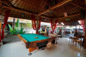 a pool table in the middle of a restaurant at Wina Holiday Villa Kuta Bali in Kuta