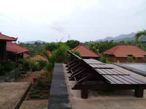 a row of benches in front of some houses at Eliska Sari Bungalows Sumberkima in Pemuteran