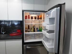 a refrigerator with its door open in a kitchen at Armonik Suites in Mexico City