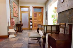 a room with a table and chairs in a room at Pepe's House Cuenca I Boutique Hotel in Cuenca