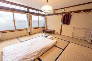 a bedroom with a bed and a window at 4S STAY Awaikeda Ekimae in Miyoshi